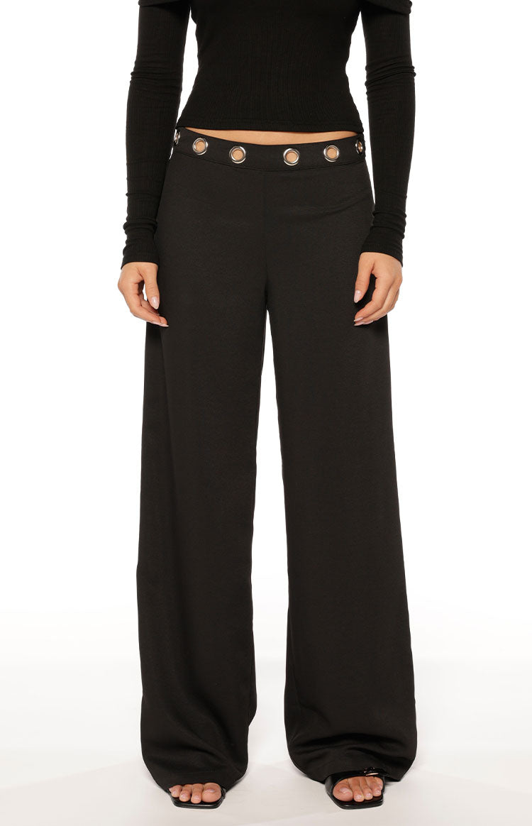 Black straight leg pants with a high waist and silver eyelet details, full length with a subtle textured fabric