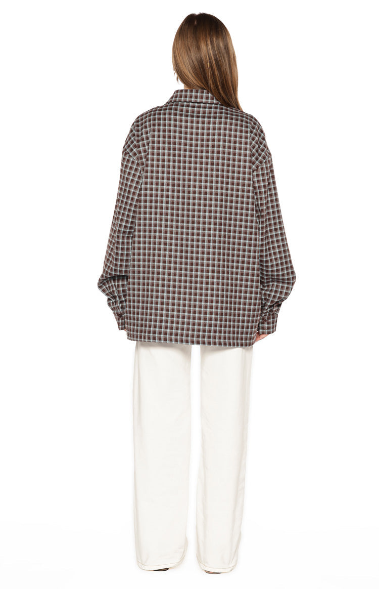 Back view of the brown plaid long sleeve shirt with a relaxed, oversized fit and dropped shoulders