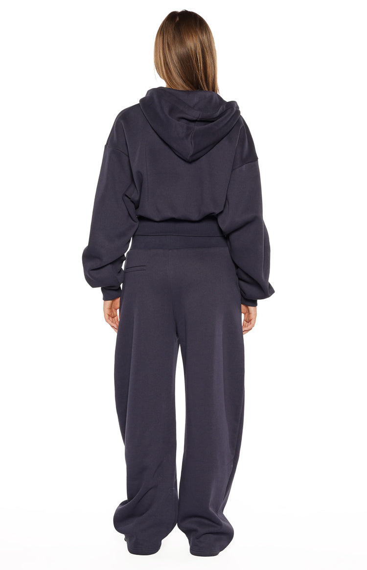 Rear view of navy barrel leg track pants with a wide elasticated waistband and relaxed, slouchy fit