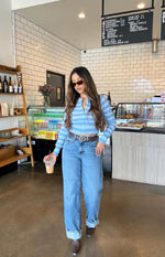 Light blue and white striped knit sweater with a full zip front, long sleeves, and a cropped fit