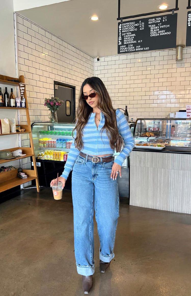 Light blue and white striped knit sweater with a full zip front, long sleeves, and a cropped fit
