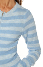 Detail shot of the soft blue and white striped knit sweater, highlighting the fuzzy texture and silver zipper