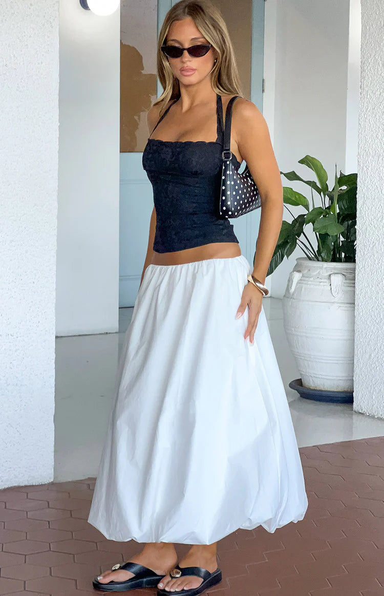Side view of a white midi bubble hem skirt with a voluminous, relaxed fit
