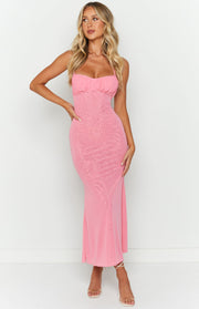 Front view of a pink maxi dress with a ruched sweetheart bust, spaghetti straps, and sheer mesh overlay