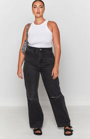 Faded black wide leg jeans featuring distressed knee rips and a raw hem