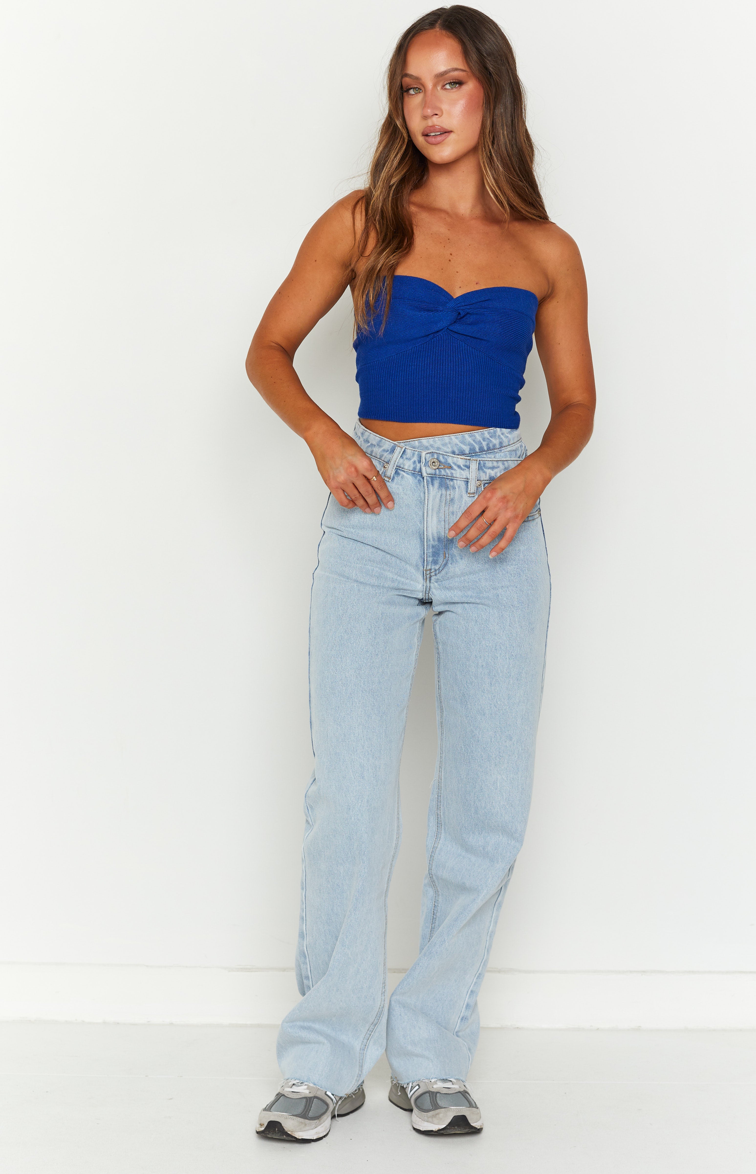 Light blue wide leg jeans with an uneven V-shaped waistline and relaxed fit