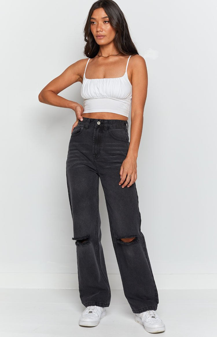 High waisted black wash wide leg jeans with distressed detail on the thigh and V-shaped back yoke
