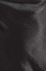 Close-up of the black mini dress fabric, showing its subtle sheen and crinkled texture