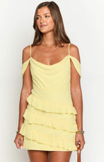 Front view of a yellow mini dress featuring a cowl neck, off-shoulder sleeves, and ruffled tiers