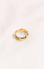 A gold-toned ring with a twisted