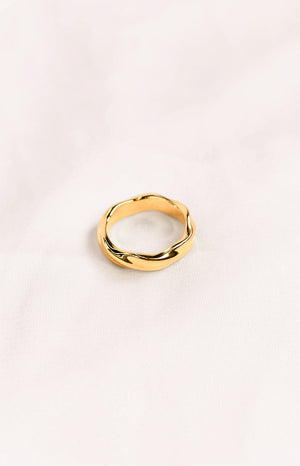 A gold-toned ring with a twisted