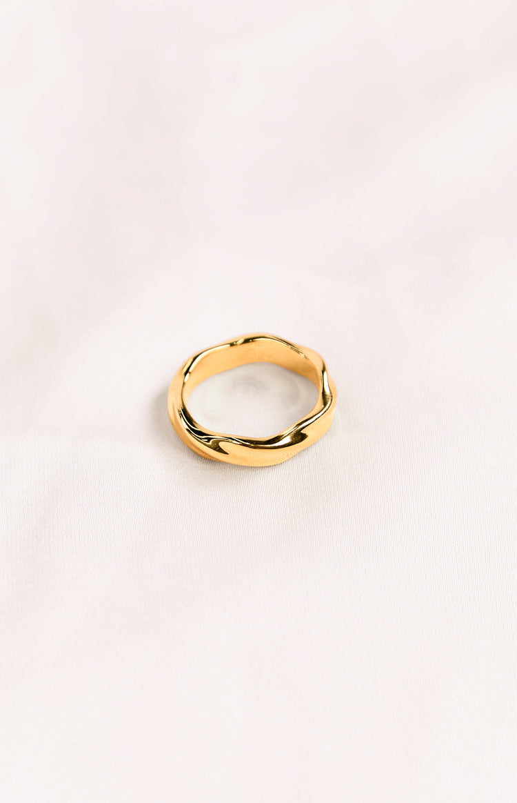 A gold-toned ring with a twisted