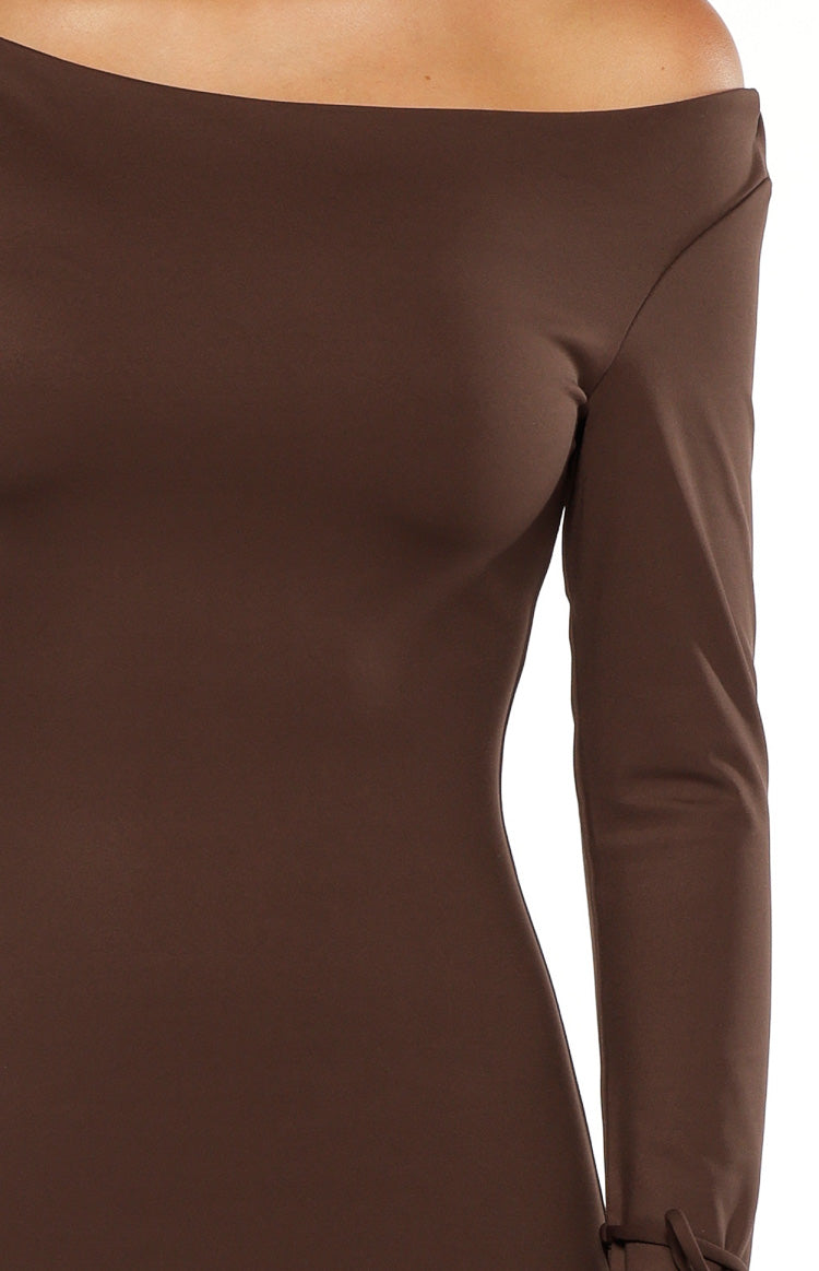 Close-up of the off-shoulder neckline and long sleeve with tie detail on a chocolate jersey maxi dress