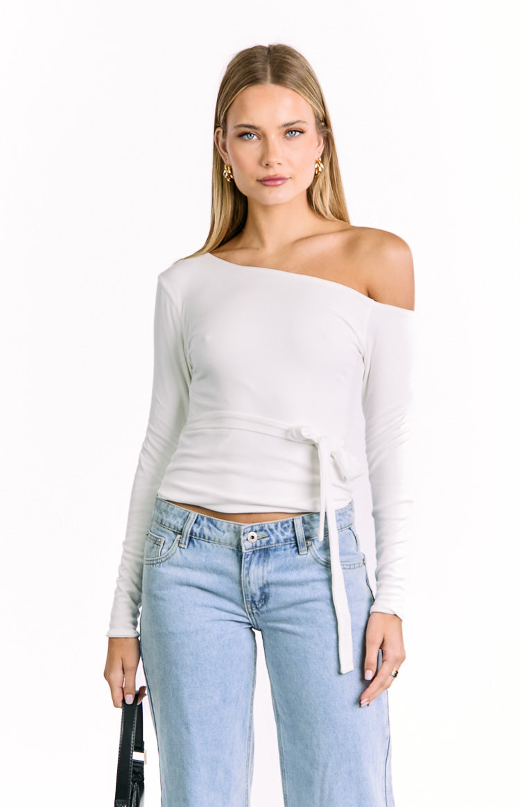 Front view of a white one-shoulder long sleeve top in a soft knit with a tie waist detail