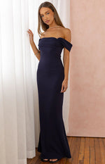 Navy off-shoulder crepe maxi dress with a folded neckline, gathered bust, and fitted silhouette