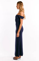 Side view of a navy crepe off-shoulder maxi dress showing the fitted silhouette and long skirt