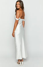 Rear-side view of a white satin off-shoulder formal dress showing the draped sleeves and flowing maxi skirt