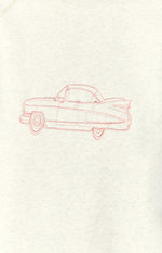 Close-up of the pink embroidered vintage car design on the grey crew neck sweater