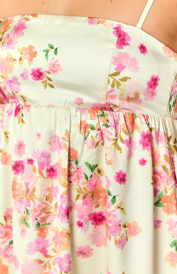 Close-up of the shirred side bodice and gathered waist of a yellow floral satin mini dress