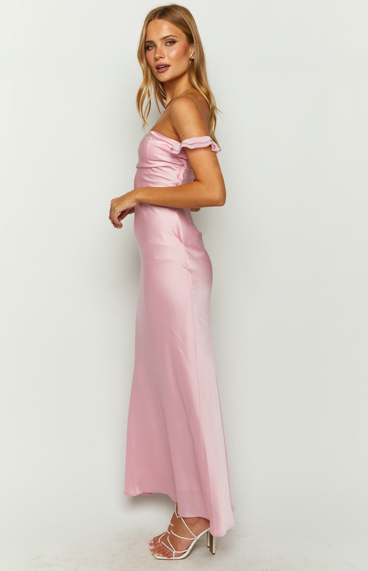 Side view of a pink satin maxi dress with off-shoulder ruffled sleeves and a flowing skirt