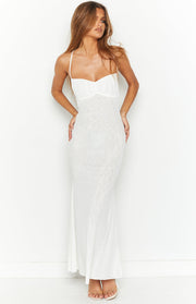 White maxi dress with a ruched sweetheart neckline, thin spaghetti straps, and a subtle patterned sheer overlay