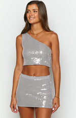 Front view of a fitted grey sequin mini skirt, showcasing the all-over shimmering sequin embellishment