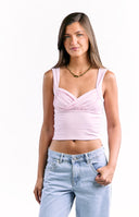 A sleeveless light pink top with wide shoulder straps and a gathered cross-over detail at the bust.