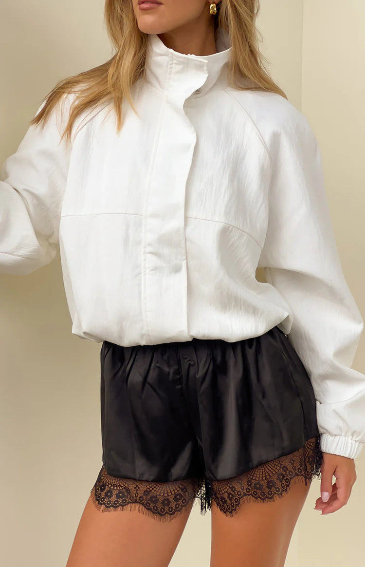 Cream funnel neck sports jacket with a relaxed fit and crinkled texture, worn open