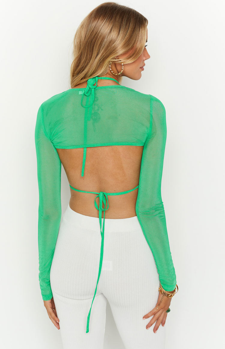 Rear view of the green mesh long sleeve crop top with open back, halter neck tie, and waist tie