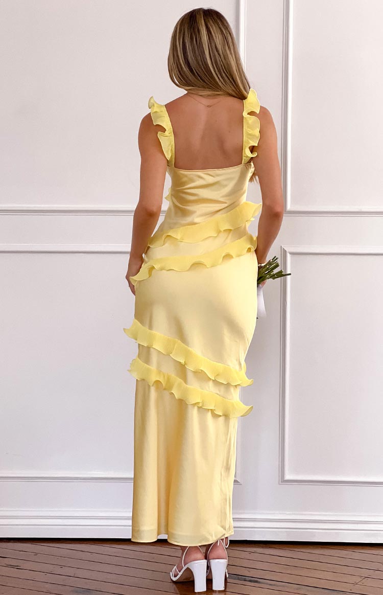 Back view of a yellow satin maxi dress with ruffled shoulder straps and horizontal tiered ruffles
