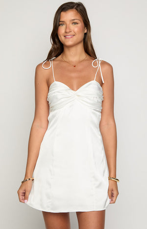 Beginning Boutique Fifi White Mini Dress white satin mini dress with a twisted sweetheart neckline and tie spaghetti straps