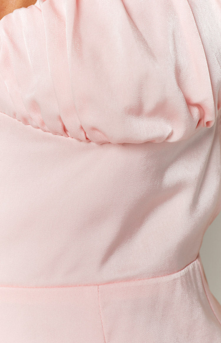 Back view of a pink satin mini dress showing the low scoop back, criss-cross straps, and invisible zipper