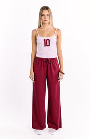 Burgundy wide leg pants with an elasticated drawstring waist and relaxed fit