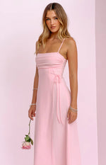 Side view of a pink maxi dress showing the ruched side detail with adjustable ties, square neckline and thin straps