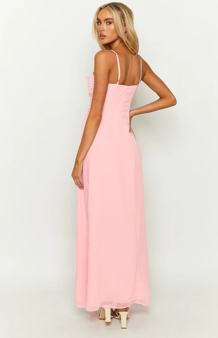 Pink sleeveless maxi dress with a ruched straight neckline, thin spaghetti straps, and a flowing A-line skirt