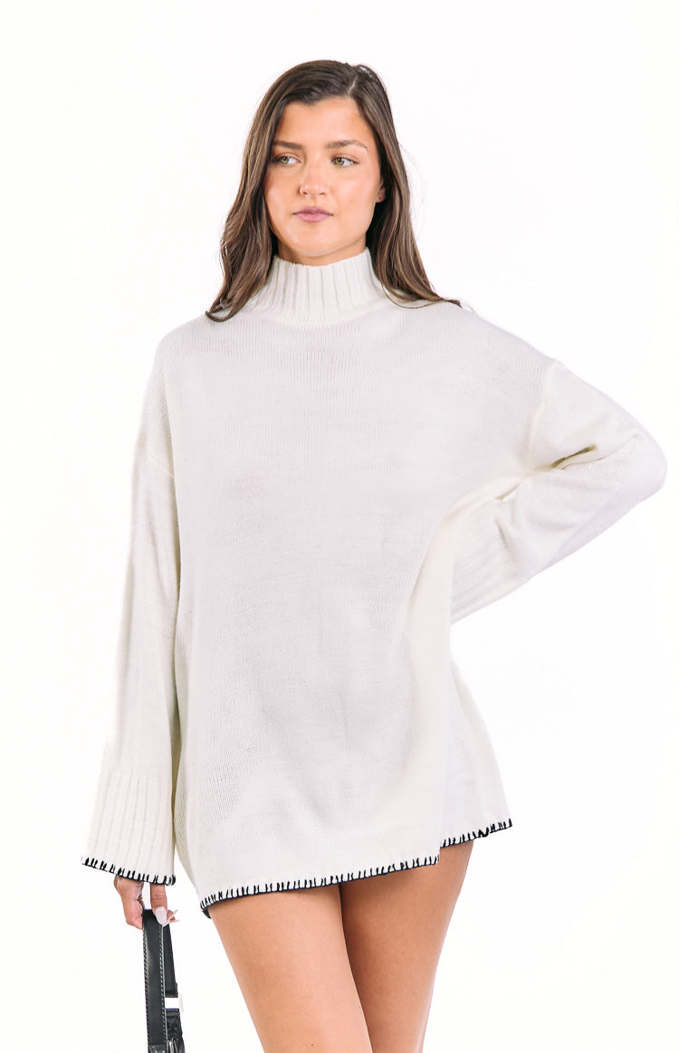 Beginning Boutique Flynn Cream Sweater Dress cream oversized knit mock neck sweater dress with long sleeves and black whipstitch trim
