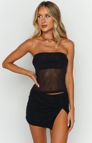 Front view of a black mesh mini skirt with an asymmetrical hem and a high thigh split