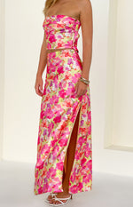 Side view of a yellow floral pop print satin maxi skirt with a high side split