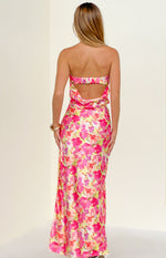 Rear view of a yellow floral pop print maxi skirt in a flowy satin-like fabric
