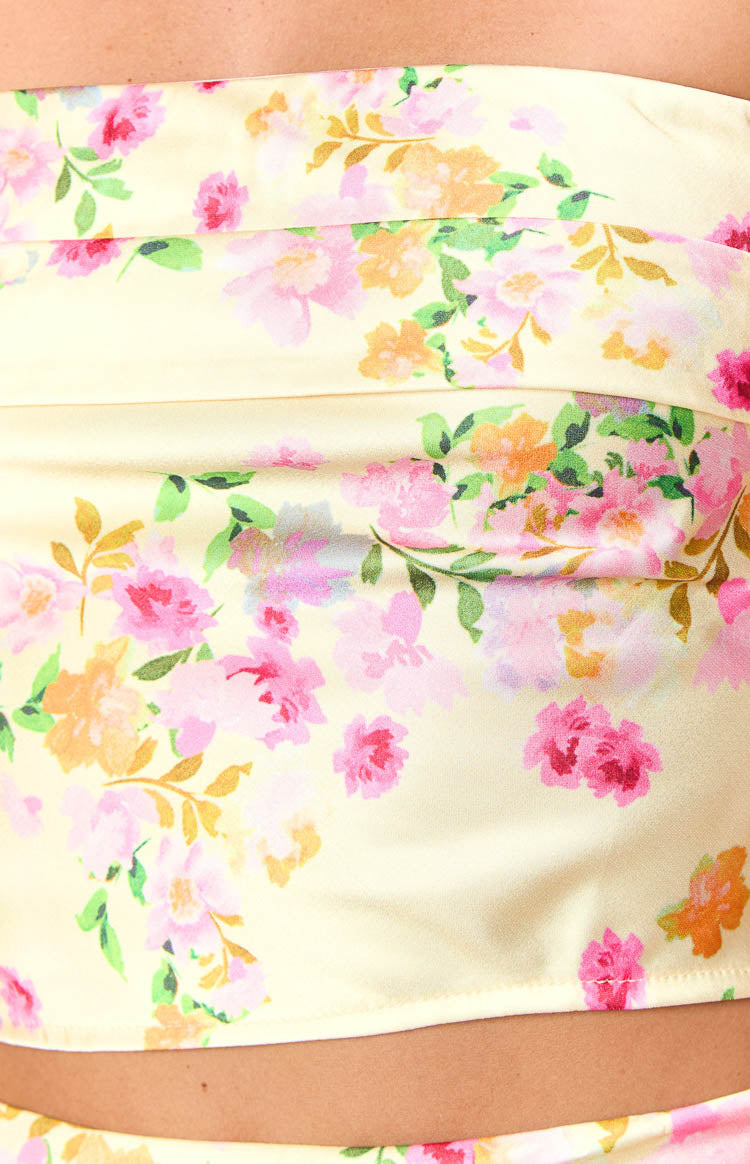 Close-up of the yellow floral print with pink and orange flowers and soft pleats