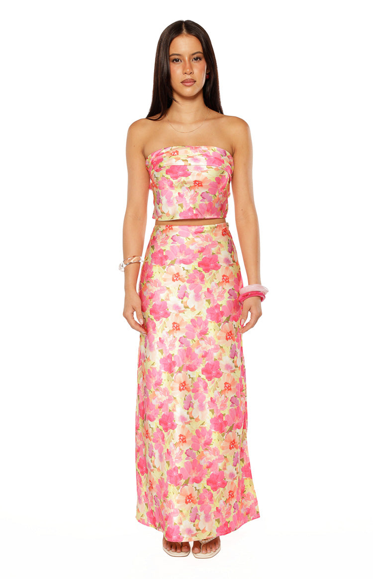 Front view of a yellow floral pop print maxi skirt with pink and orange flowers, in a flowy satin fabric
