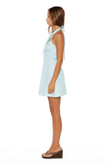 Side view of a light blue halter neck mini dress with A-line skirt, drawstring waist, and floral embroidery