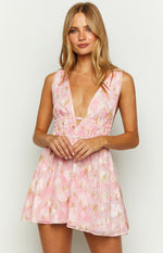 Front view of a pink floral chiffon mini dress with a deep V-neckline, ruched waist, and small cutout