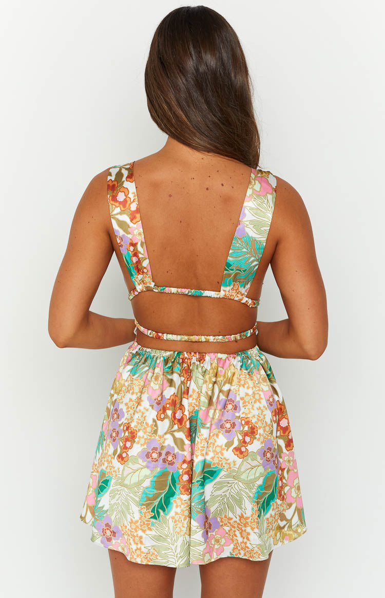 Close-up of the shirred waist and side cutouts on a tropical floral mini dress
