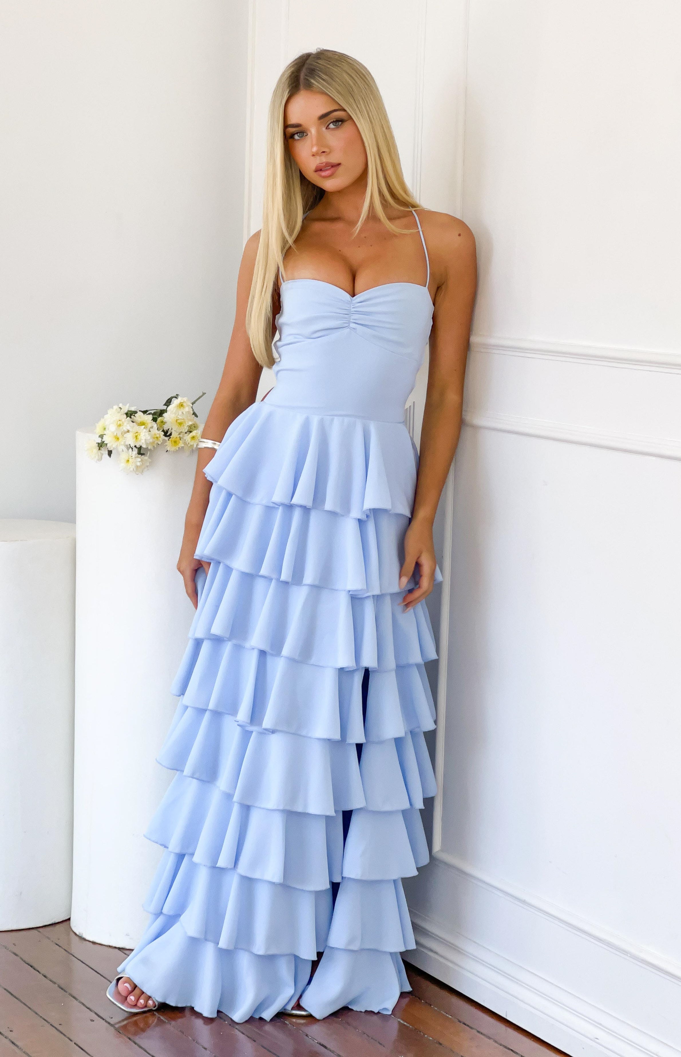 Full length view of a light blue tiered ruffle maxi dress with a ruched sweetheart neckline