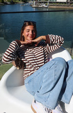 Chocolate and white stripe long sleeve top with a high neckline and ribbed brown cuffs