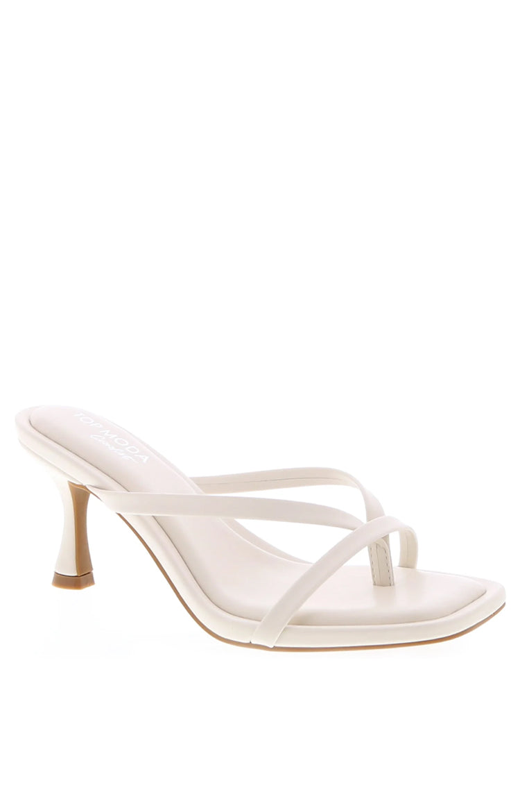 Side view of ivory kitten heels with thin criss-cross straps, a square toe, and flared kitten heel