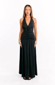 Black halter V-neck maxi dress with a fitted ruched bodice and a flowing A-line skirt