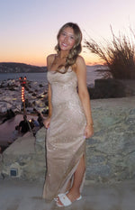 Gold bodycon slip formal dress with spaghetti straps, straight neckline, side split, and wavy glitter pattern