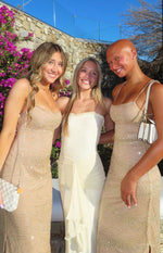Cream strapless mesh maxi dress with a ruffled neckline and draped ruched fabric detail on the front skirt